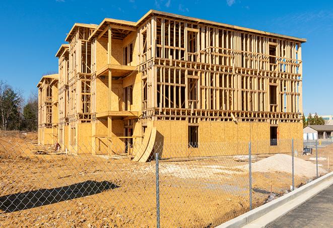 a close-up of temporary chain link fences enclosing a construction site, signaling progress in the project's development in Polk City